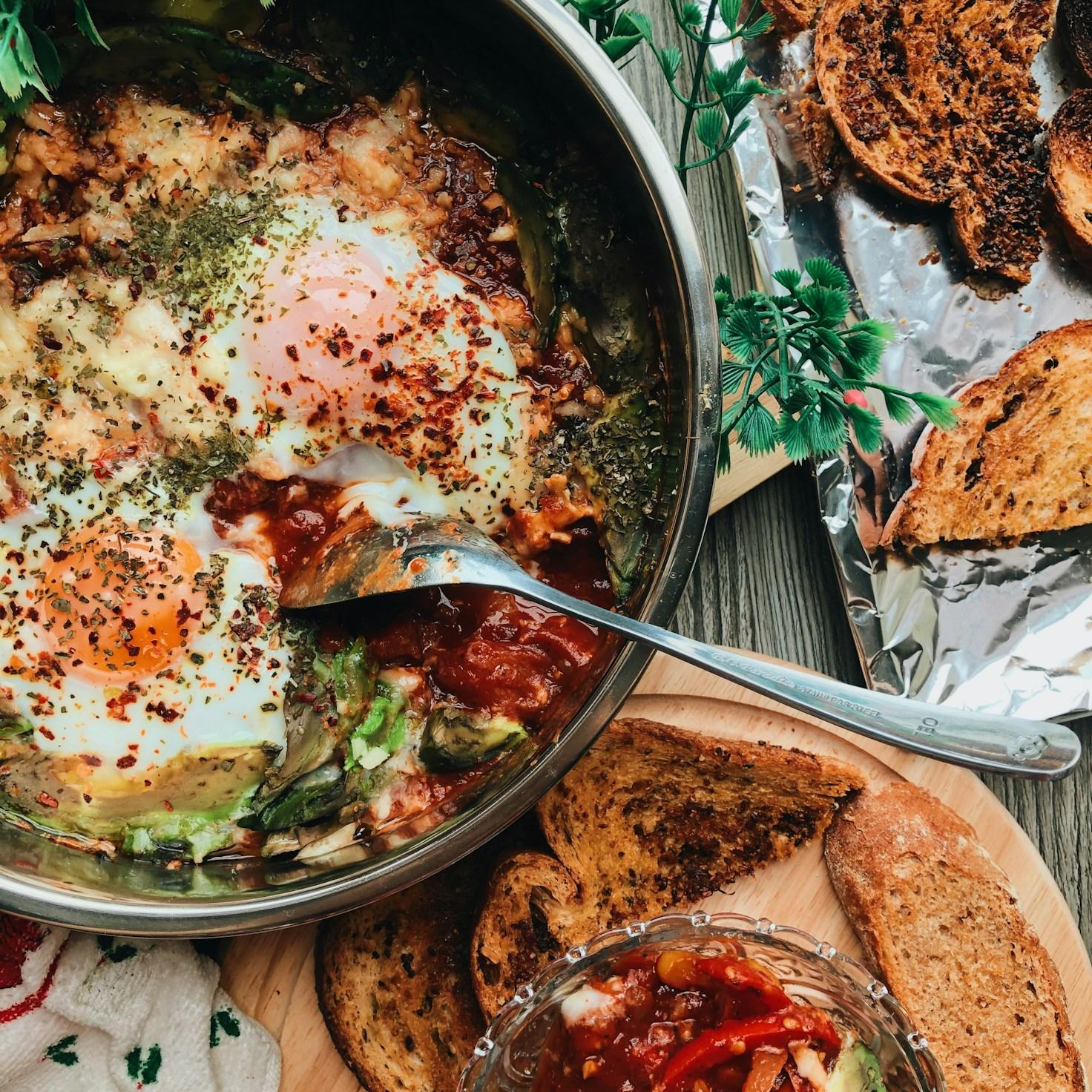Diverse group of community members sharing a meal together, showcasing the social bonds formed through collaborative cooking